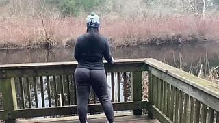Dark-haired momma in sexy yoga pants shakes her big booty by the lake